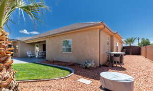 Rear view of house with central air condition unit and a patio