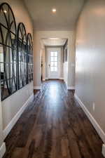 Hall featuring dark wood-type flooring