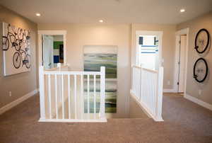 Hallway featuring carpet flooring