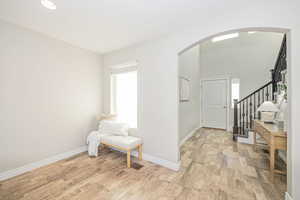 Entrance foyer with light wood-type flooring