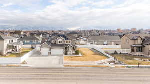 View of front of property with a garage and a mountain view