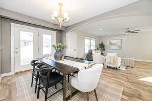 Dining room featuring light hardwood / wood-style floors and ceiling fan with notable chandelier