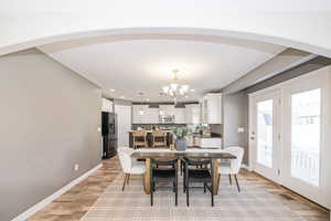 Dining room featuring light hardwood / wood-style floors and a chandelier