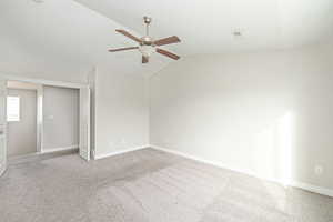 Unfurnished bedroom featuring lofted ceiling, light colored carpet, and ceiling fan