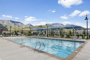 View of swimming pool featuring a patio and a mountain view