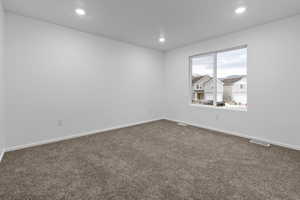 Primary bedroom with carpet flooring