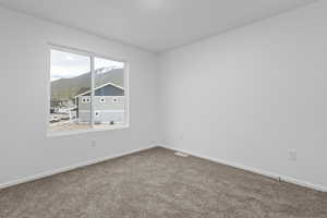 Carpeted empty room with a mountain view