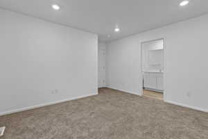 Primary bedroom with carpet flooring