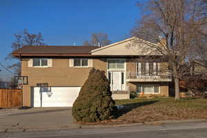 Split foyer home featuring a garage