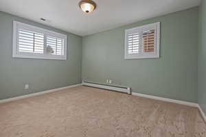 Unfurnished room featuring a baseboard radiator