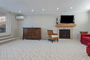 Living area featuring baseboard heating, a wall mounted air conditioner, a tile fireplace, and crown molding