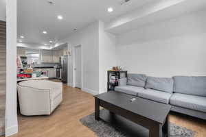 Living room with light hardwood / wood-style floors