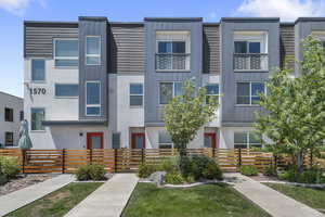 Contemporary home featuring a fenced front yard and stucco siding