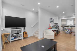 Living room with light hardwood / wood-style flooring