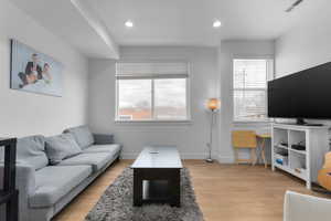 Living room with light hardwood / wood-style floors