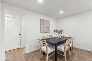 Dining space with light hardwood / wood-style floors