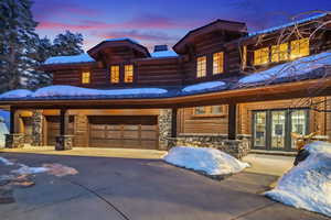 View of front facade featuring a garage and french doors