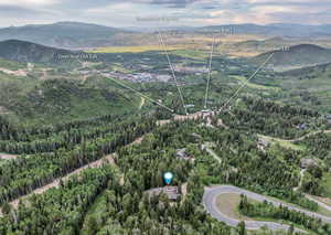 Bird's eye view of a mountainous background and a heavily wooded area