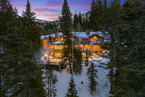 Snow covered rear of property featuring a mountain view