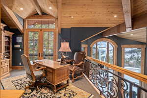 Carpeted home office featuring high vaulted ceiling, beam ceiling, french doors, and wood ceiling