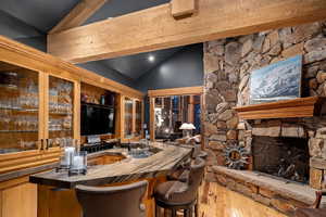 Bar featuring sink and vaulted ceiling with beams