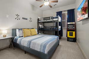 Bedroom featuring ceiling fan and carpet