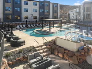 View of swimming pool with a patio area and a mountain view