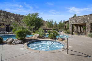 View of pool featuring a mountain view, a hot tub, and a patio