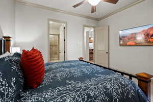 Bedroom with connected bathroom, ceiling fan, and ornamental molding