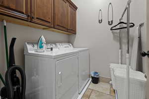 Laundry area with washer and dryer and cabinets