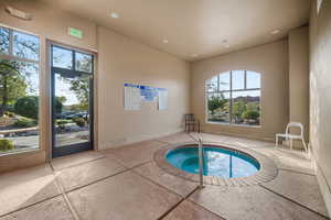 View of swimming pool with an indoor in ground hot tub