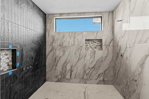 Bathroom featuring tiled shower