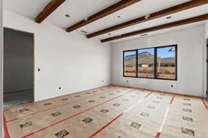 Spare room featuring beamed ceiling