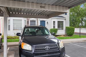 View of parking with a carport