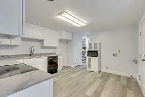 Kitchen area with view of laundry area. Both gas and electric available for dryer