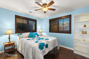 Bedroom featuring dark wood-type flooring and ceiling fan