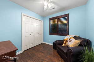 Sitting room featuring ceiling fan and dark hardwood / wood-style flooring