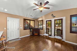 Foyer entrance featuring ceiling fan, vaulted ceiling, and dark hardwood / wood-style floors