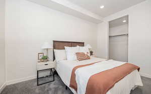 Carpeted bedroom featuring a spacious closet and a closet