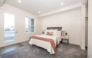 Carpeted bedroom featuring access to outside