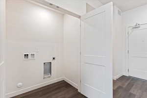 Laundry area featuring hookup for an electric dryer, hookup for a washing machine, hookup for a gas dryer, and dark hardwood / wood-style floors