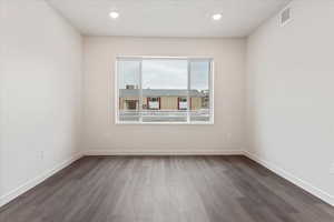 Unfurnished room with dark hardwood / wood-style floors