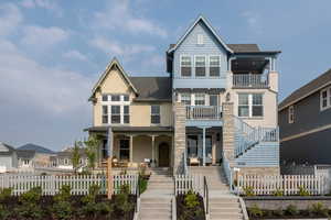 View of front of property with a covered porch and two raised decks