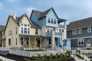 View of front of property with a covered porch and two raised decks