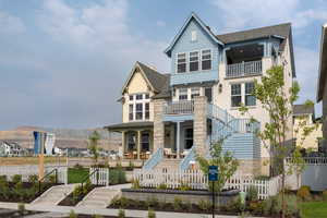 View of front of property with a covered porch and two raised decks