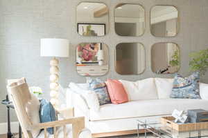 Living room with V-grooving and beamed ceiling, hardwood / wood-style flooring, and  wallpaper