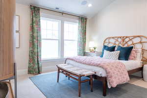 Secondary bedroom with a lofted ceiling and study nook