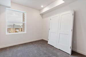 Unfurnished bedroom with a closet and carpet