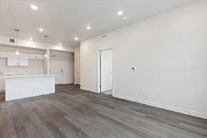 Unfurnished living room with dark hardwood / wood-style flooring