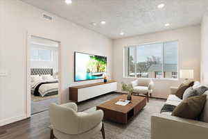 Living room featuring wood-type flooring and a textured ceiling